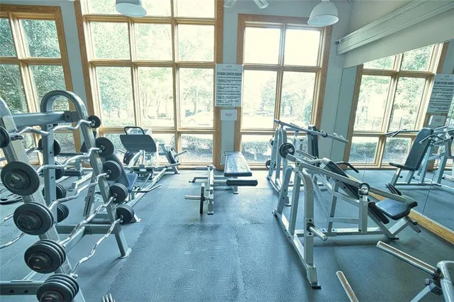 a view of a livingroom with furniture and floor to ceiling windows