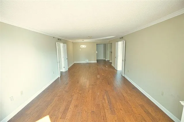 a view of hallway with wooden floor