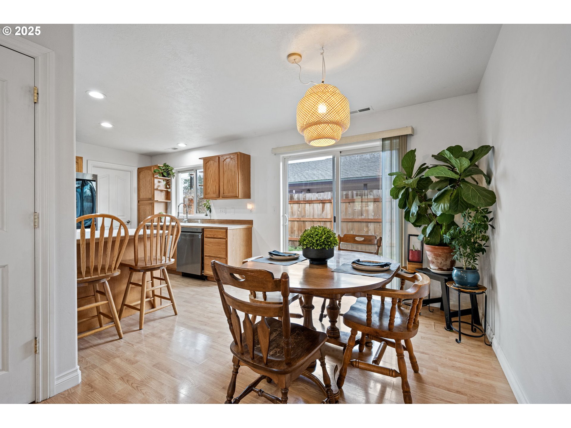 3785 Dove Lane Eugene, OR 97402 - Photo 12 of 43 a view of a dining room and kitchen with furniture and a potted plant