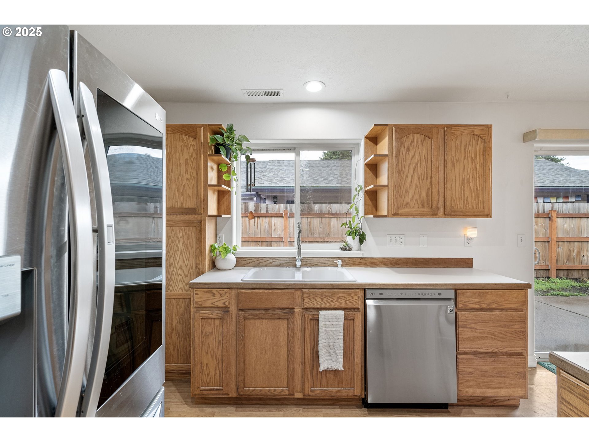 3785 Dove Lane Eugene, OR 97402 - Photo 14 of 43 a kitchen with stainless steel appliances a sink and a refrigerator