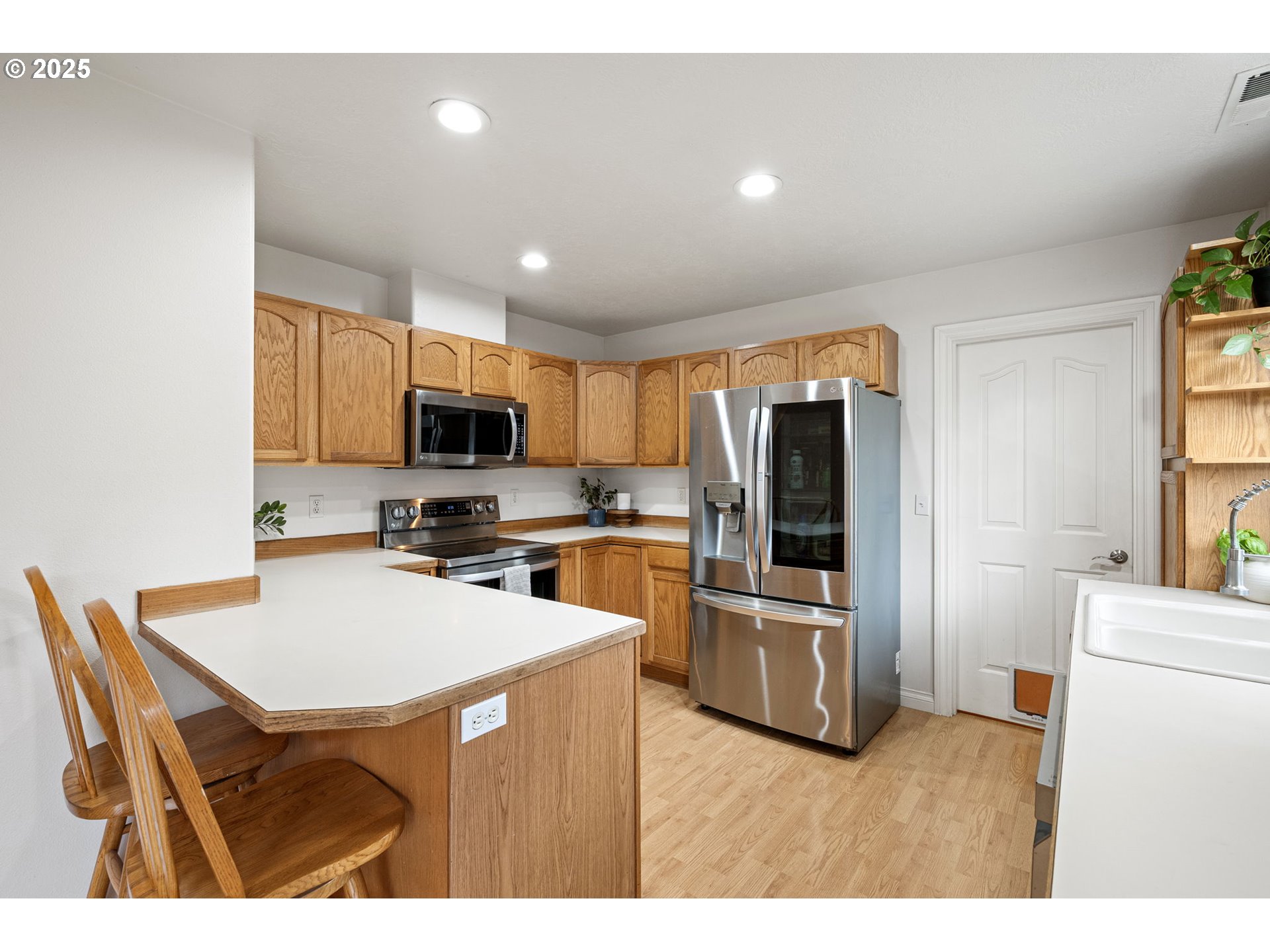 3785 Dove Lane Eugene, OR 97402 - Photo 15 of 43 a kitchen with refrigerator cabinets and wooden floor