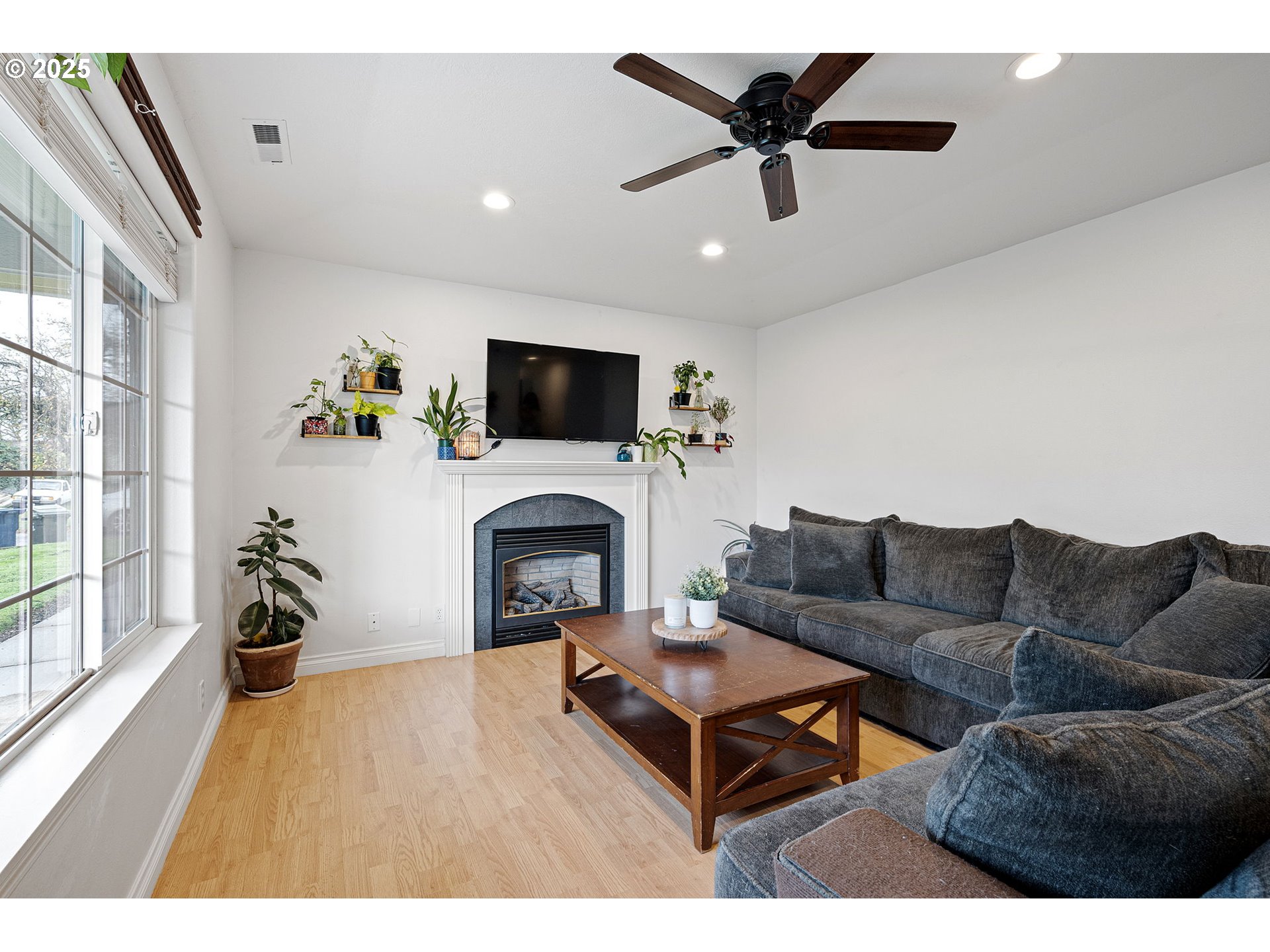 3785 Dove Lane Eugene, OR 97402 - Photo 19 of 43 a living room with furniture a fireplace and a flat screen tv