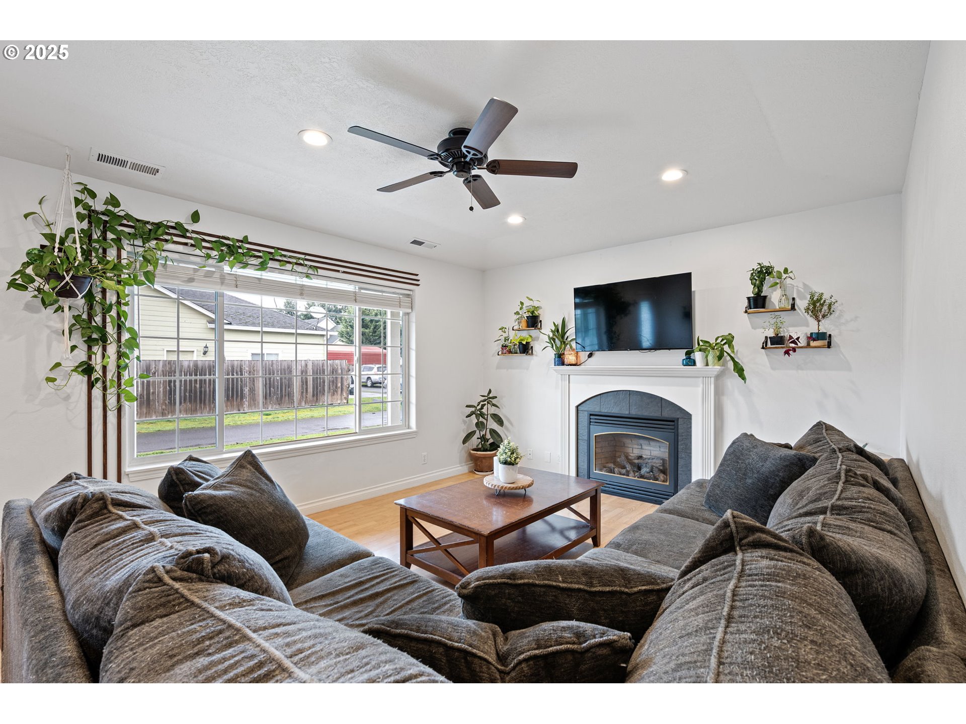 3785 Dove Lane Eugene, OR 97402 - Photo 20 of 43 a living room with furniture a fireplace and a floor to ceiling window