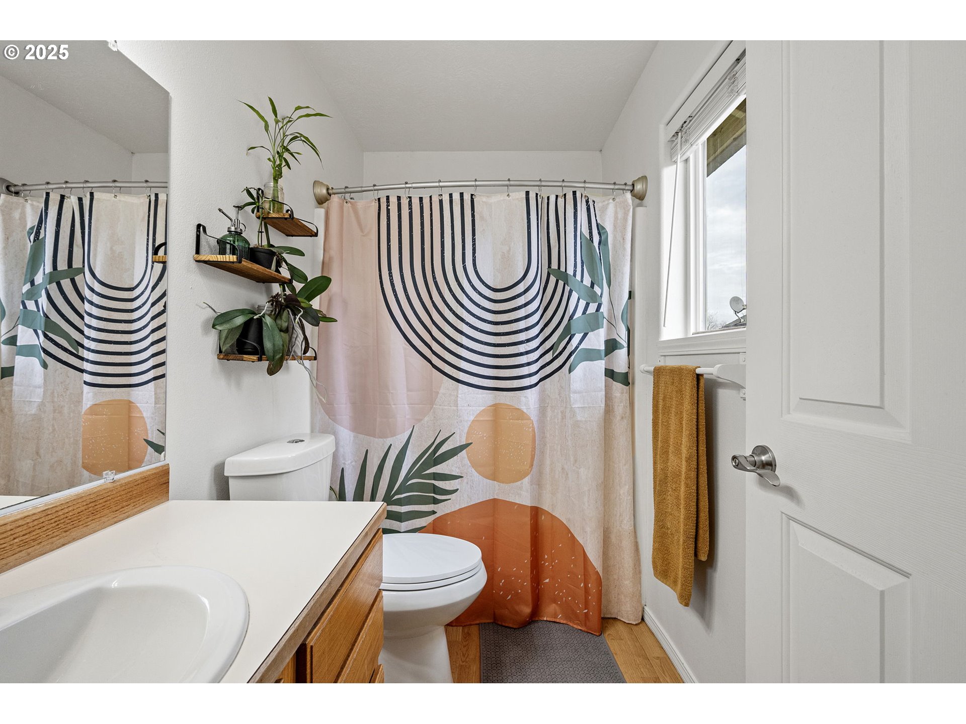 3785 Dove Lane Eugene, OR 97402 - Photo 26 of 43 a bathroom with a sink a toilet a mirror and a shower