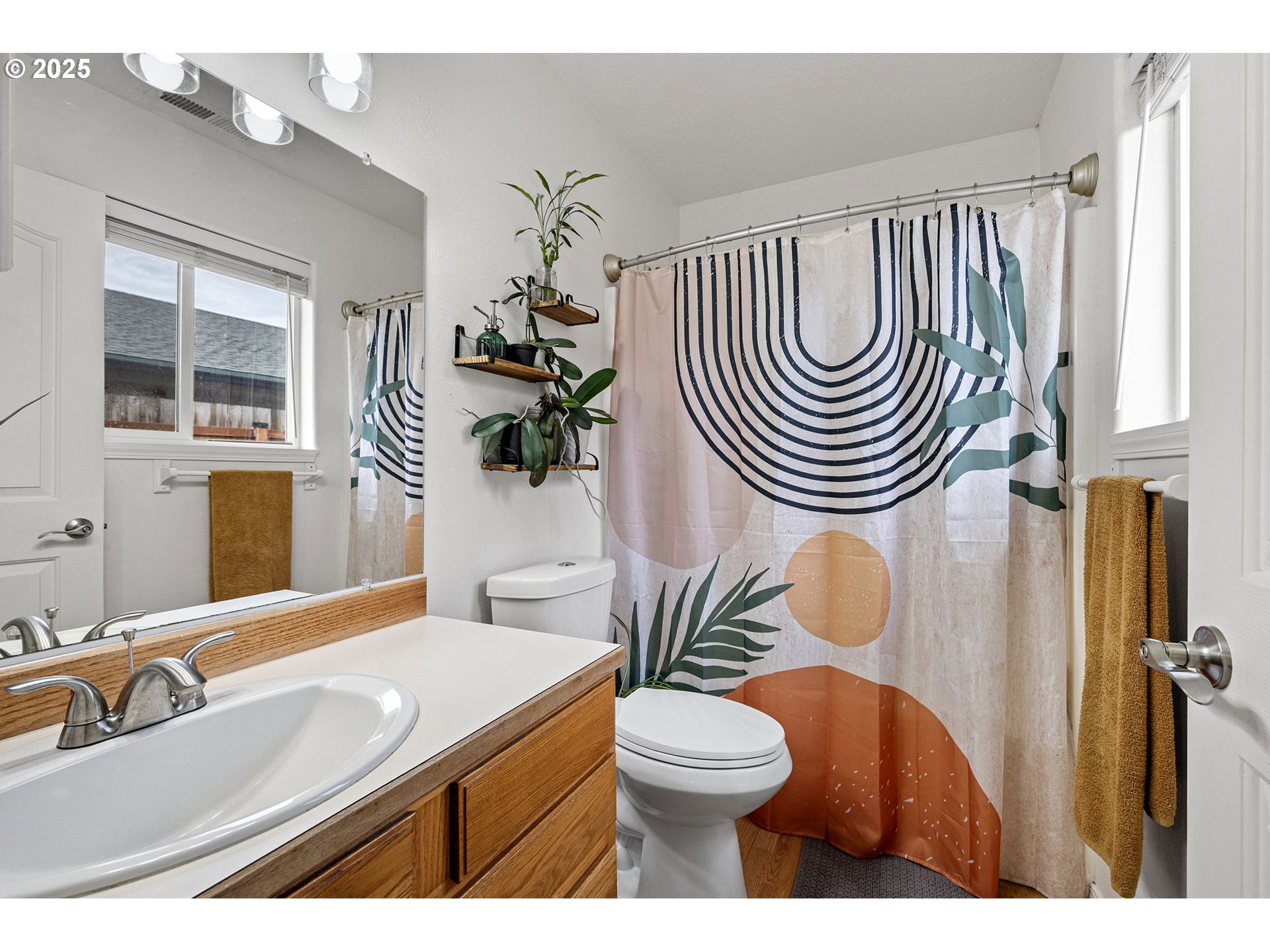 3785 Dove Lane Eugene, OR 97402 - Photo 27 of 43 a bathroom with a sink a mirror a toilet and a mirror