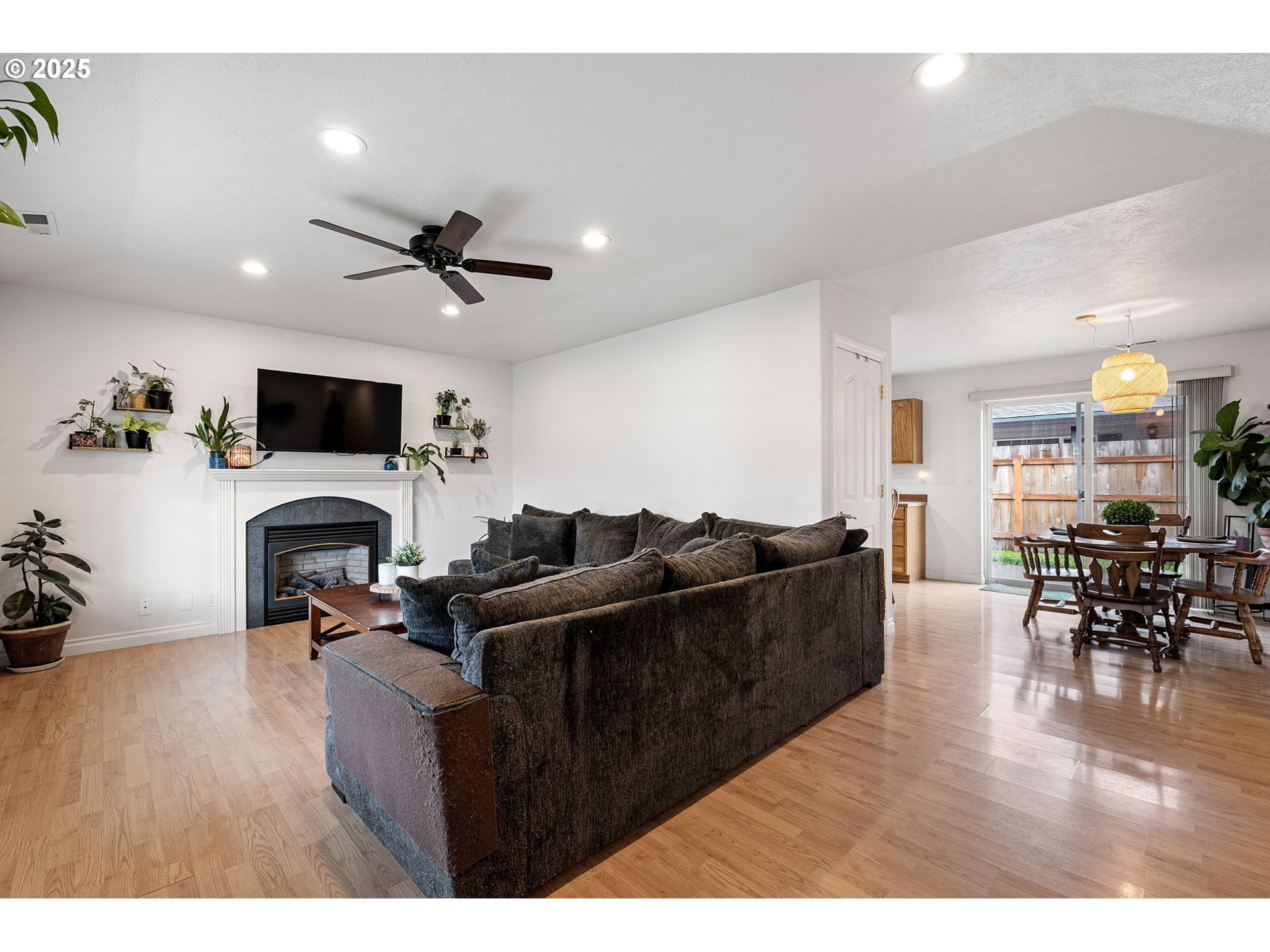 3785 Dove Lane Eugene, OR 97402 - Photo 3 of 43 a living room with furniture a fireplace and a flat screen tv