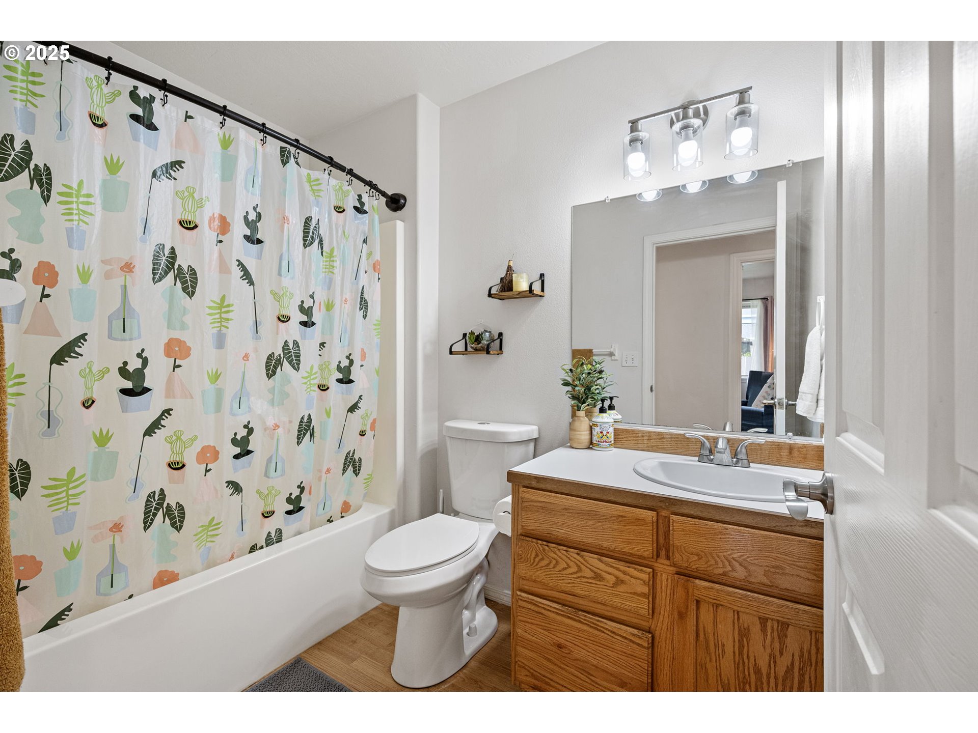 3785 Dove Lane Eugene, OR 97402 - Photo 34 of 43 a bathroom with a sink a toilet a mirror a lamp and shower curtain