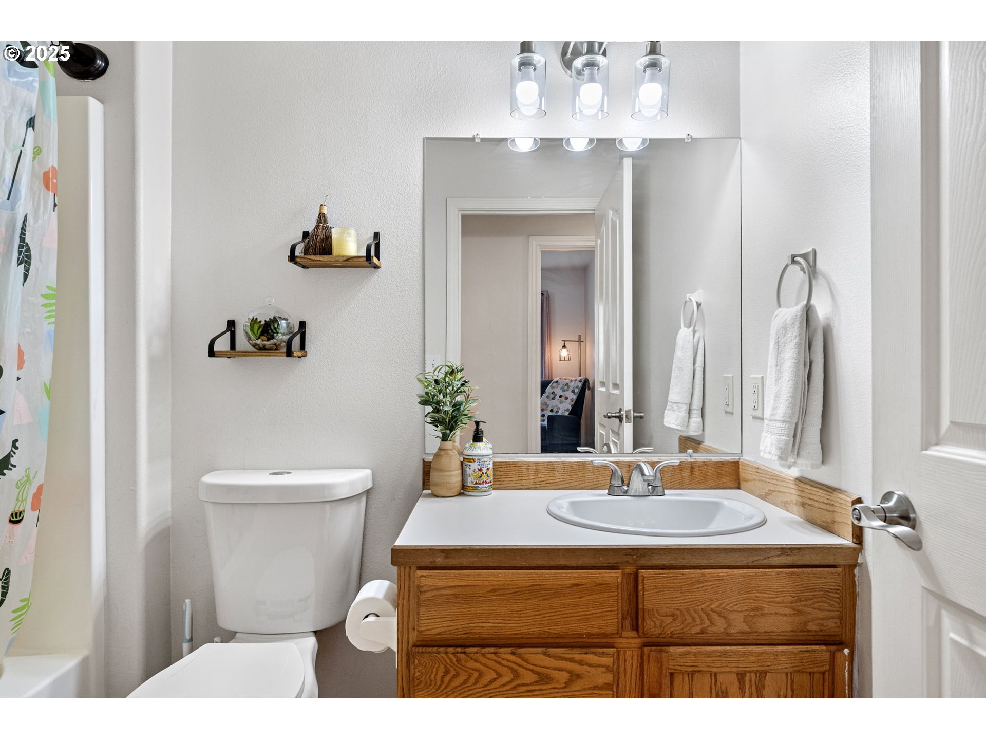 3785 Dove Lane Eugene, OR 97402 - Photo 35 of 43 a bathroom with a sink a toilet and a mirror
