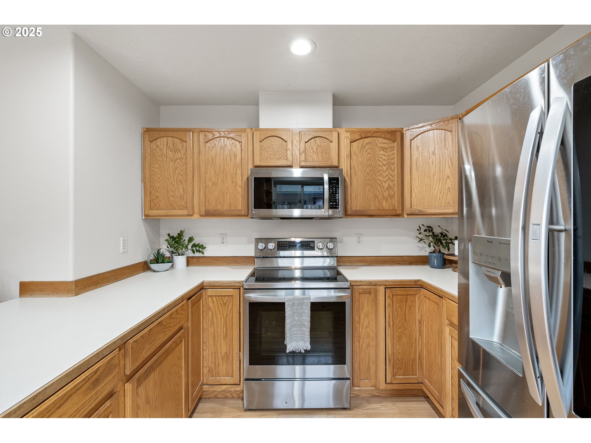 3785 Dove Lane Eugene, OR 97402 - Photo 4 of 43 a kitchen with stainless steel appliances a stove a sink and a refrigerator