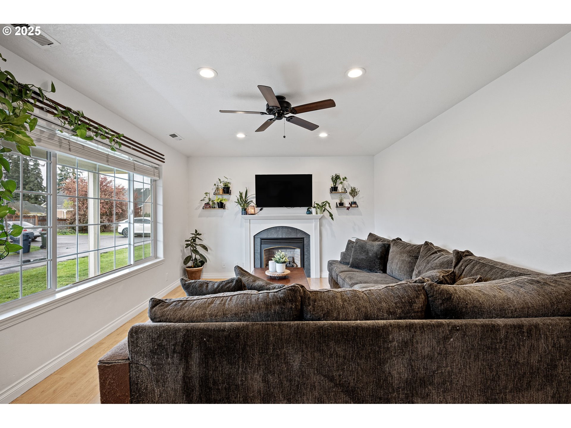 3785 Dove Lane Eugene, OR 97402 - Photo 6 of 43 a living room with furniture a fireplace and a flat screen tv