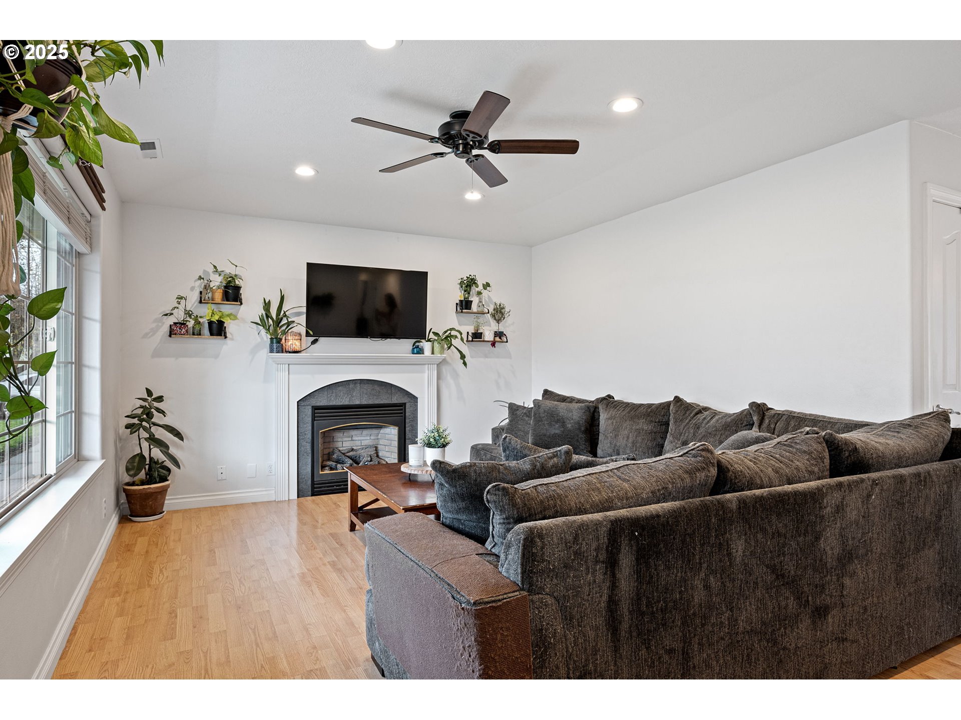 3785 Dove Lane Eugene, OR 97402 - Photo 8 of 43 a living room with furniture a fireplace and a flat screen tv
