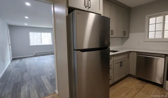 a kitchen with a refrigerator and a sink