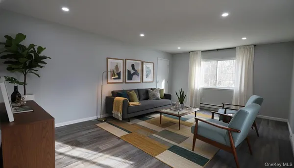 a living room with furniture rug and window