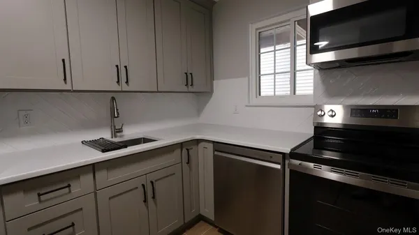 a kitchen with a sink and cabinets