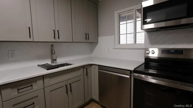 a kitchen with a sink and cabinets