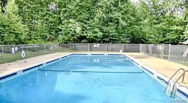 a view of swimming pool with a yard