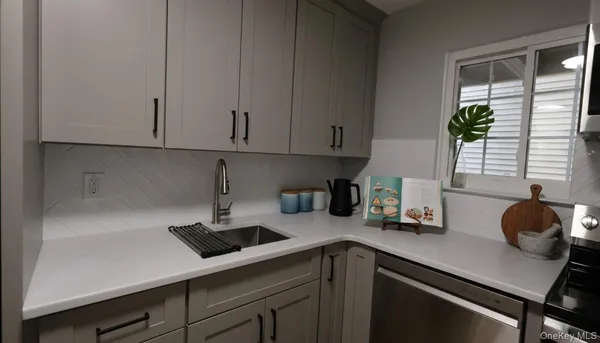 a kitchen with a sink cabinets and window