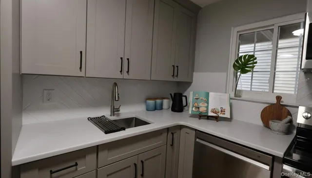 a kitchen with a sink cabinets and window