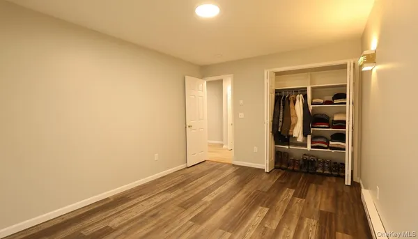 a view of a bedroom with furniture and windows