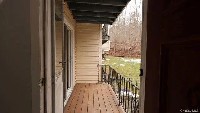 a view of a balcony with wooden floor