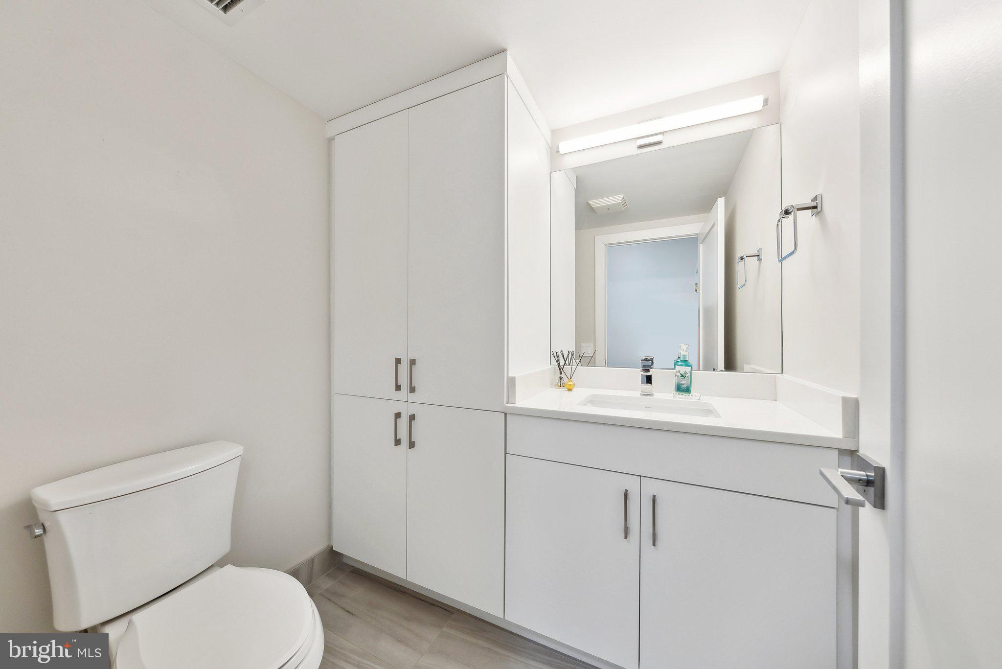 631 D Street Northwest, Unit 241 Washington, DC 20004 - Photo 13 of 81 a bathroom with a toilet a sink and mirror