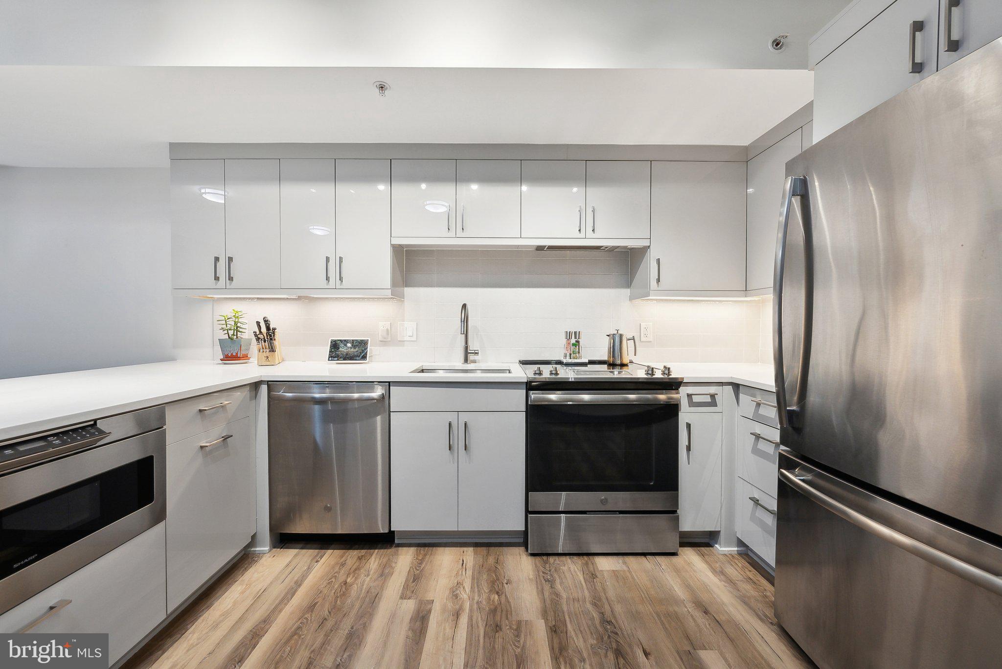 631 D Street Northwest, Unit 241 Washington, DC 20004 - Photo 5 of 81 a kitchen with a sink stainless steel appliances and cabinets