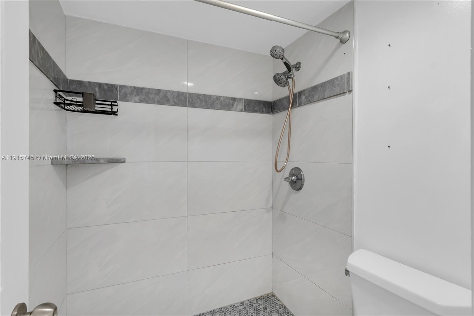 10400 Southwest 108th Avenue, Unit A413 Miami, FL 33176 - Photo 11 of 25 a bathroom with a shower a toilet and sink