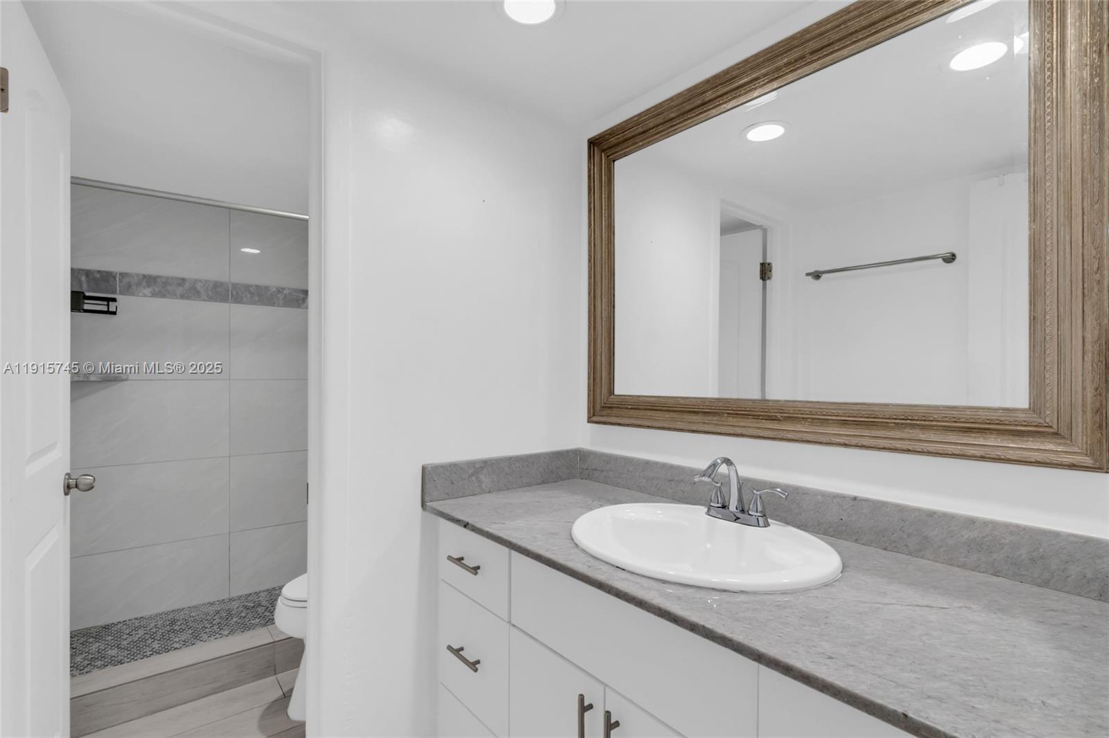 10400 Southwest 108th Avenue, Unit A413 Miami, FL 33176 - Photo 12 of 25 a bathroom with a sink and a mirror