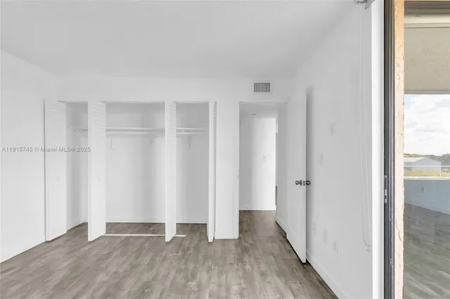 a view of a room with wooden floor