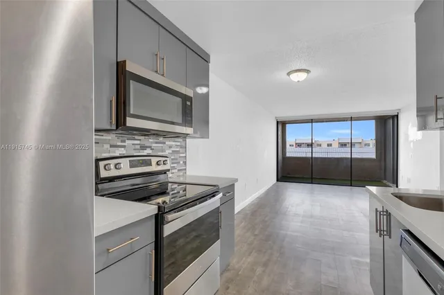a kitchen with granite countertop a stove and a microwave