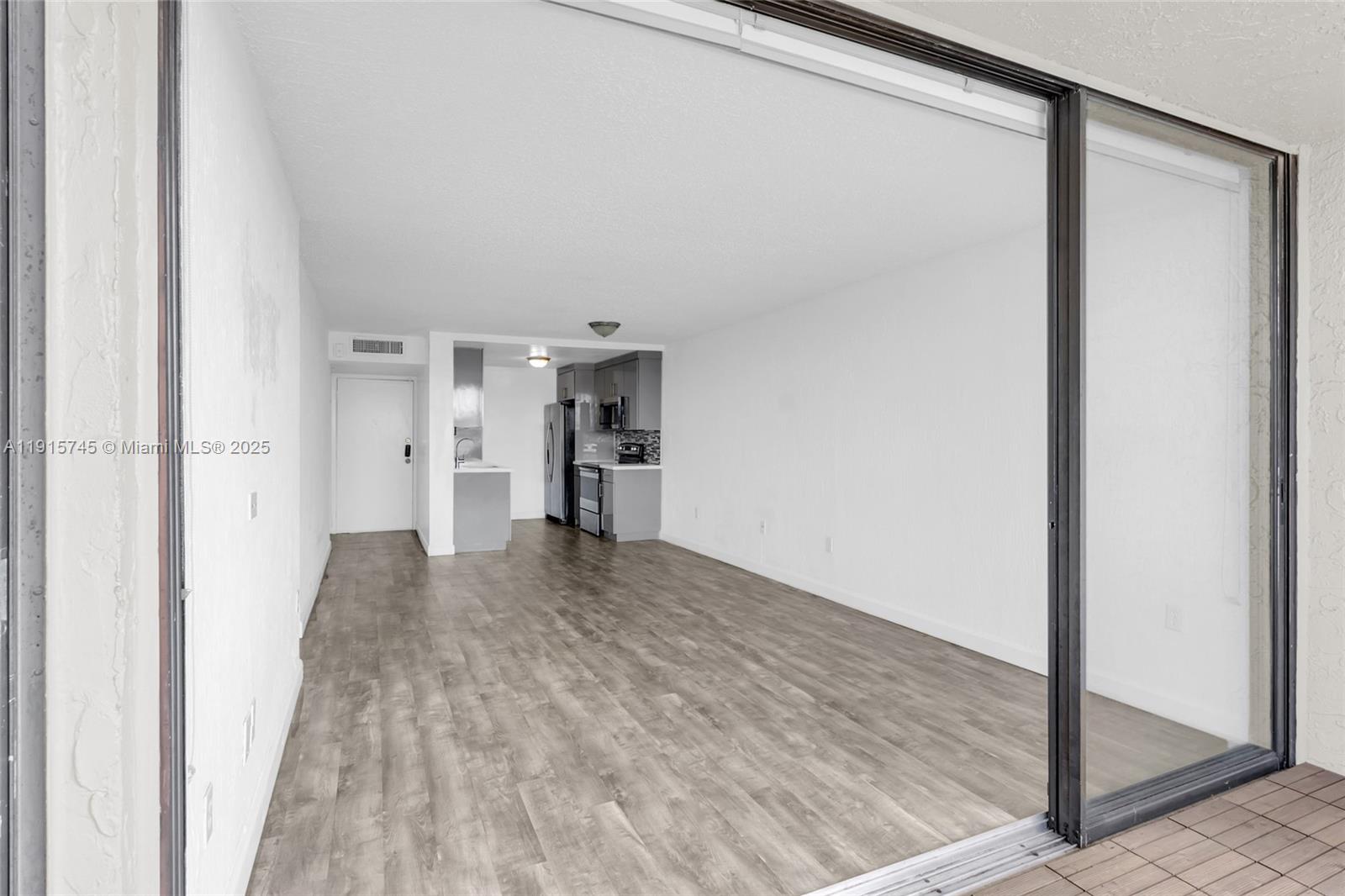 10400 Southwest 108th Avenue, Unit A413 Miami, FL 33176 - Photo 9 of 25 a view of empty room with wooden floor