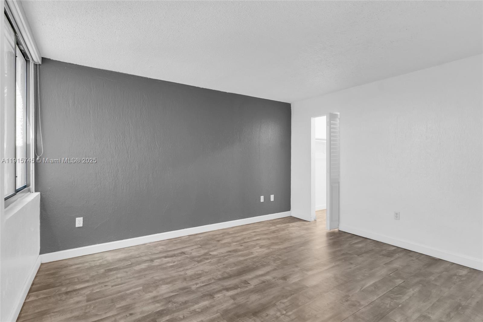 10400 Southwest 108th Avenue, Unit A413 Miami, FL 33176 - Photo 10 of 25 a view of an empty room with wooden floor