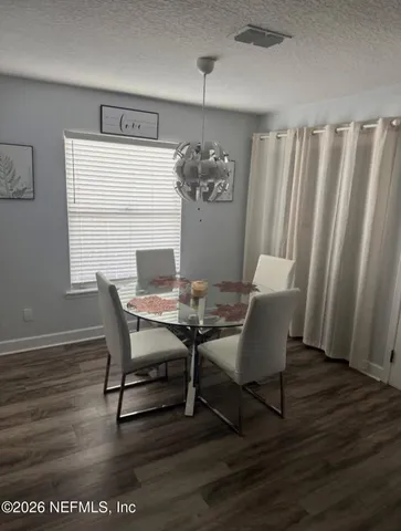 a view of a dining room with furniture and window