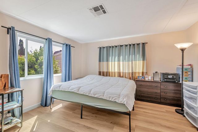 a bedroom with a bed and a book shelf