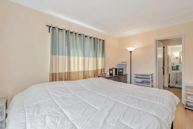 a large bedroom with a bed and a large mirror