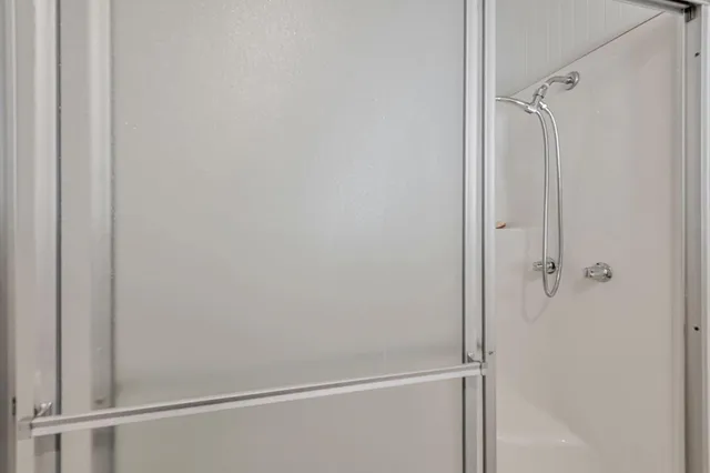 a bathroom with a glass shower door