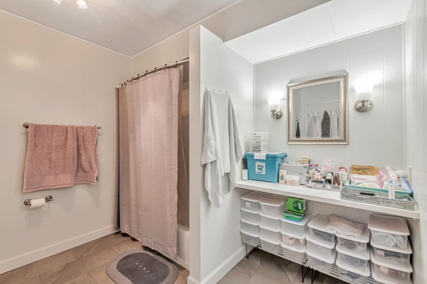 29129 Verdi Road, Unit 29129 Hayward, CA 94544 - Photo 22 of 37 a bathroom with a sink a mirror and a shower