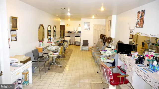 a living room with lots of furniture and painting on the wall