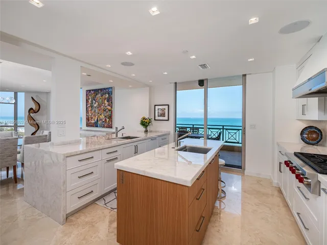 a kitchen with counter top space sink stove and outdoor