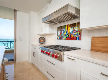 a kitchen with stainless steel appliances granite countertop a stove and a sink