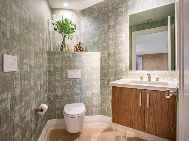 a bathroom with a toilet sink and shower