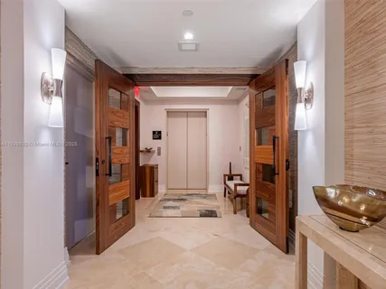 a view of a hallway to a livingroom and a livingroom