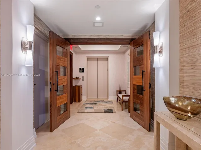 a view of a hallway to a livingroom and a livingroom