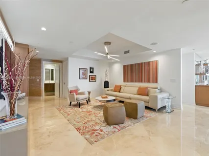 a living room with lots of furniture and a potted plant