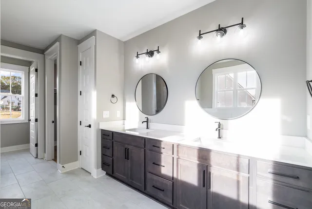 a bathroom with a double vanity sink and a mirror