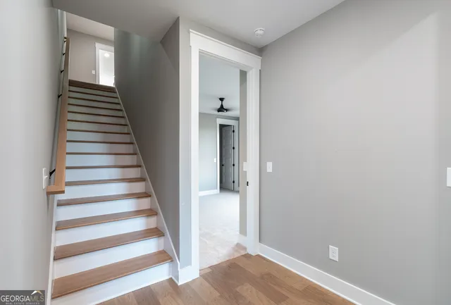 a view of a hallway with wooden floor and entryway