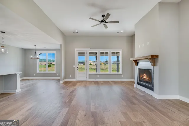 a view of an empty room fire place and a window
