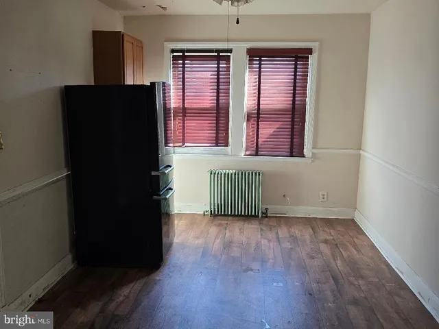 a kitchen with granite countertop white cabinets and a sink