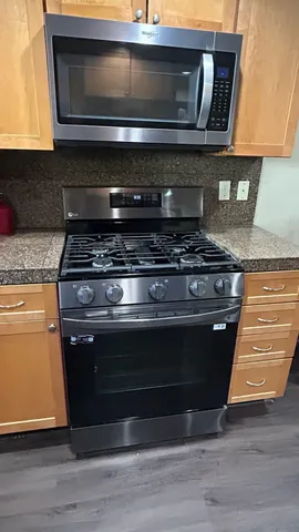 a stove top oven sitting inside of a kitchen