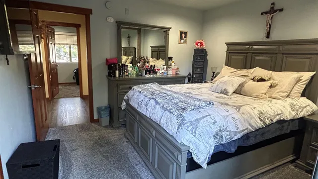 a bedroom with a bed and a mirror